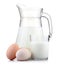 Jug of milk and glass with eggs on white