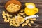 Jug milk, plastic spoon and brown bowl on table