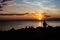 Juggler performance with many balls on the beach of the mediterranean sea in trieste, italy while sunset. Only silhouette visible