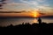 Juggler performance with many balls on the beach of the mediterranean sea in trieste, italy while sunset. Only silhouette visible