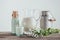 jugs, bottle and glass of fresh milk with chamomile flowers