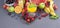 Juice in bottles, different and in a glass. Assorted berries and fruits. Gray background. Detox food. Copy space
