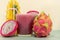 Juice in glass cup and fresh fruit and twigs of pitaya (Hylocereus polyrhizus