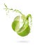 Juice splashes out of a cut lime on a white background