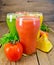 Juice tomato and vegetables in glasses on board