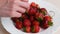 Juicy appetizing tasty strawberry on a white plate.