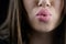 Juicy big lips of a young woman send a kiss