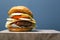 Juicy burger with cutlet, cheese and vegetables on a gray background with copy space. double cheeseburger on a wooden  board