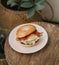 A juicy cheeseburgers with sesame seed buns on a red patterned plate