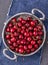 Juicy cherries in round metal bowl