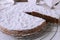 Juicy chocolate almond cake on a cooling rack. Traditional italian torta caprese on white background