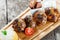 Juicy delicious meat cutlets and hominy ,Corn porridge Polenta, with goat cheese on cutting board on wooden background