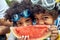 Juicy Delight: Afro-American Siblings\' Playful Peek-a-Boo from a Watermelon Slice