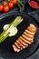 Juicy duck breast steaks with caramelized asparagus. Black background. Top view