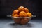 Juicy fresh tangerines with water drops lie in a metal colander on a light concrete background