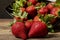 juicy freshly grown strawberries spilling out of a bowl