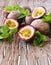 Juicy fruit Granadilla with mint on a wooden table