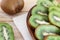 Juicy kiwi slices on a wooden plate on the table close-up, delicious fruit wood, dietary products, healthy ingredients, tropical f