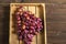 Juicy large bunch of grapes in a wooden box close-up. Ripe grapes and copy space. An abundance of grapes with grape seed