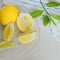 Juicy lemons and slices in transparent fancy dish.