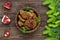 Juicy liver cutlets with pomegranate seeds on a ceramic plate on a dark wooden background.