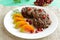 Juicy liver cutlets with pomegranate seeds on a white plate