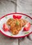 juicy meat-chicken chops and tomatoes on a white plate on a simple light linen background served with a fork and knife