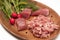 Juicy meat chopped in minced close-up served with large pieces of raw meat fresh vegetables, seasoning and herbs