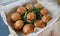 Juicy mini burgers with onion rings, jalapeno pepper, cucumbers, lettuce, cheese on a white box