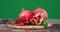 Juicy pomegranate with leaves on cutting Board rotates slowly.