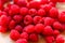 Juicy raspberries lying on wooden board