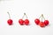 Juicy red cherries single double triple with stems in one frame on a white background