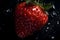 Juicy red strawberry with water droplets on a black background.