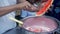 A juicy red watermelon / Tarbooj being cut into slices and put in the milk