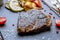 Juicy Ribeye steak on black stone