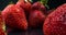 Juicy ripe berries. Strawberries close-up. Macro shot of strawberries on black background.