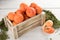 Juicy ripe Italian tangerines in a wooden box on a white background