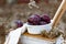 Juicy ripe large plums, spherical full shape. Liquid fruit in a ceramic oval shape on a wooden chair stool.