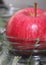 Juicy ripe red Apple stands on the neck of the jar, harvesting for the winter, preservation of fruit