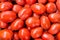 Juicy ripe red tomatoes as an abstract background.