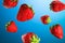 Juicy ripe strawberries on blue background. 3d rendering
