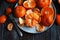 Juicy ripe tangerines on a plate. Peeling a tangerine. Skins of citrus