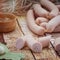 Juicy sausages for barbecue wooden table background.Homemade hotdog sausages