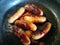 Juicy seasoned sausages frying