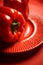 Juicy shiny bell pepper on a red background