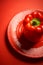 Juicy shiny bell pepper on a red background