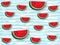 Juicy slices of red watermelon on a background of horizontal wavy strips of blue color, as sea waves