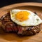 juicy steak topped with a fried egg, medium done