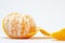 Juicy tangerine closeup photo on white background. Bright orange citrus fruit. Whole tangerine peel off