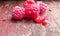 Juicy tasty raspberries. Red berries on an old shabby bench. Healthly food